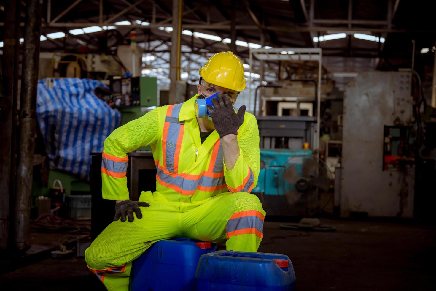 Engineer industry wearing safety uniform ,black gloves ,gas mask feel suffocate when under checking chemical tank in industry factory work. photo