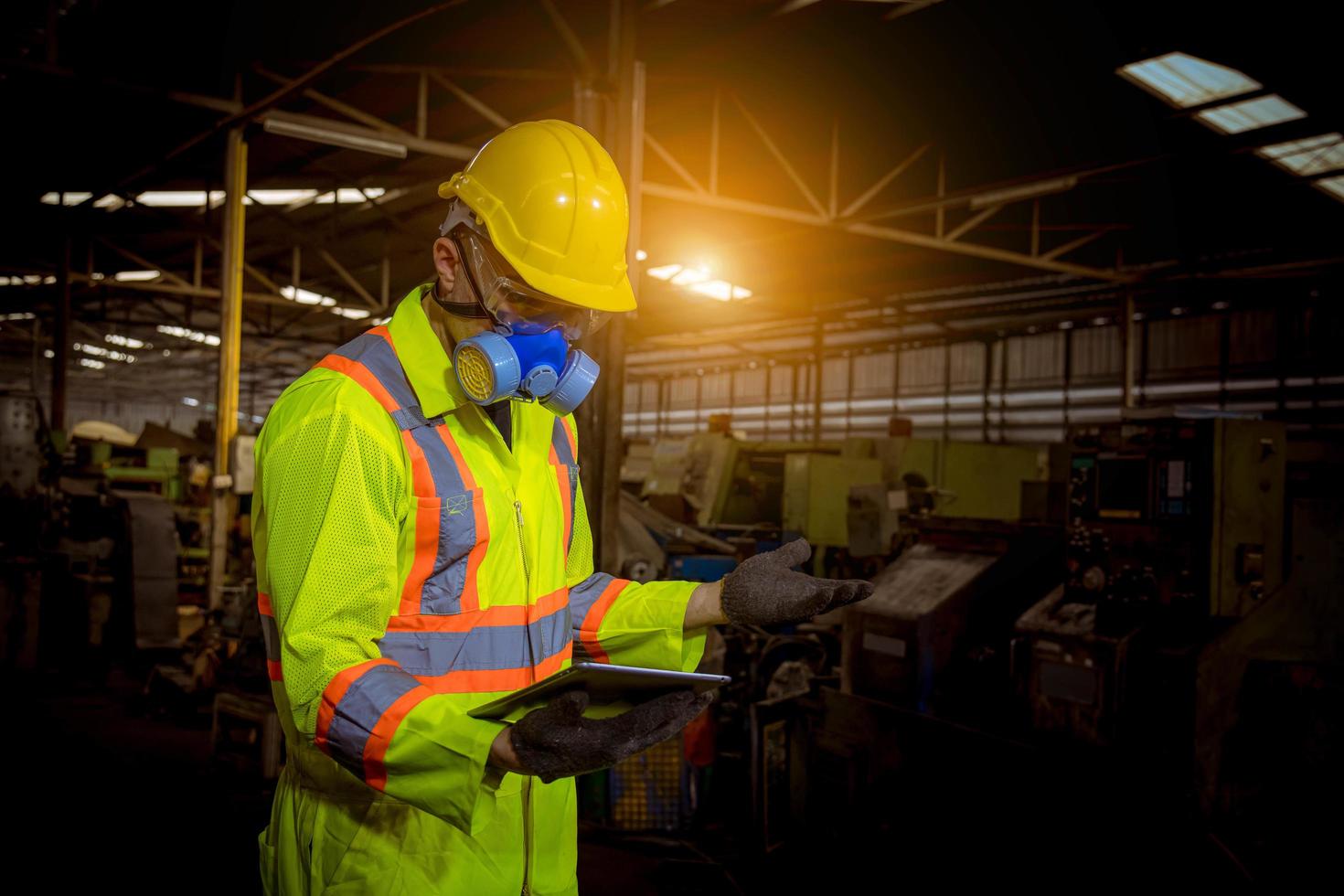 Engineer industry wearing safety uniform ,black gloves ,gas mask feel suffocate when under checking chemical tank in industry factory work. photo