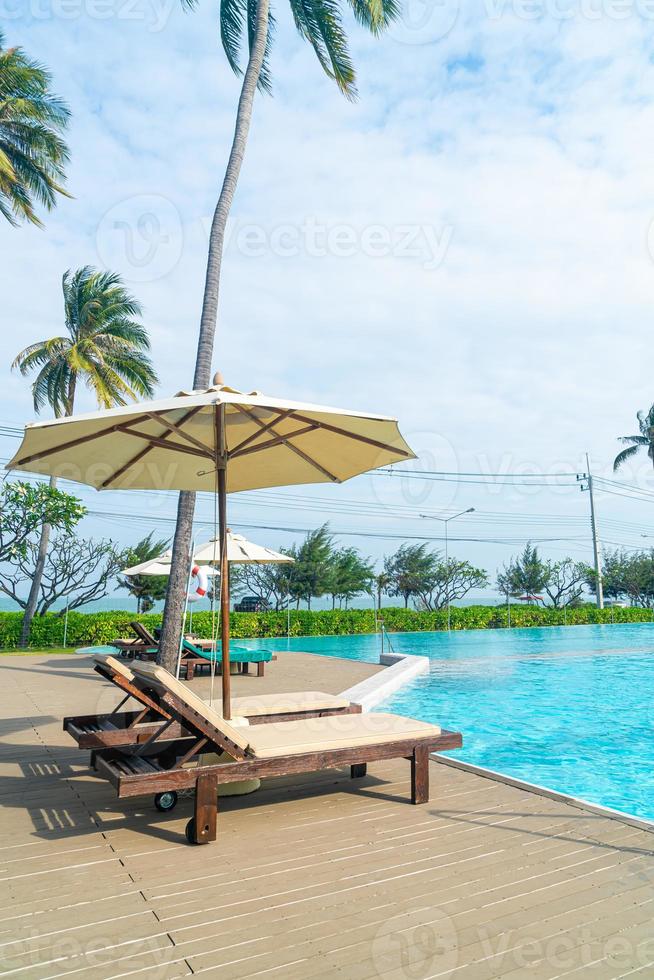 umbrella with bed pool around swimming pool with ocean sea background