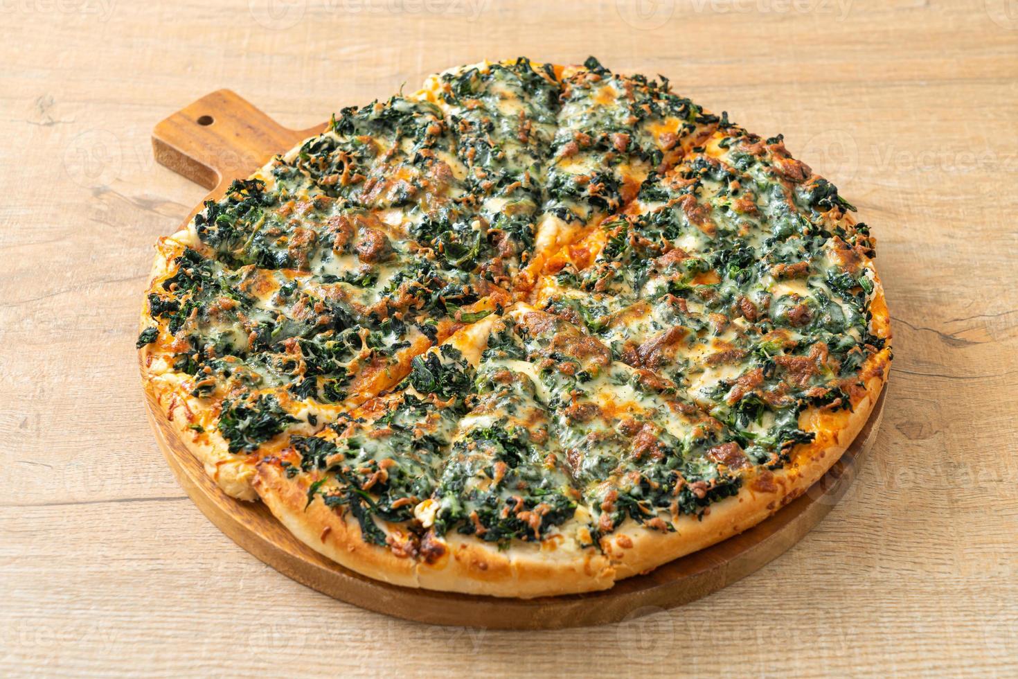 spinach and cheese pizza on wood tray photo