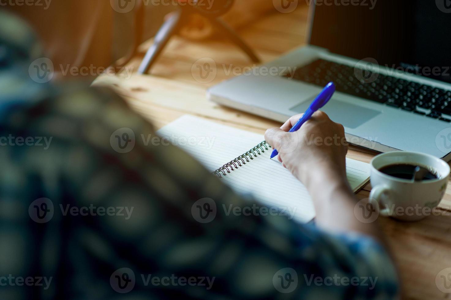 Writing on paper at work on the table in the morning, business ideas. There is space for copying. photo
