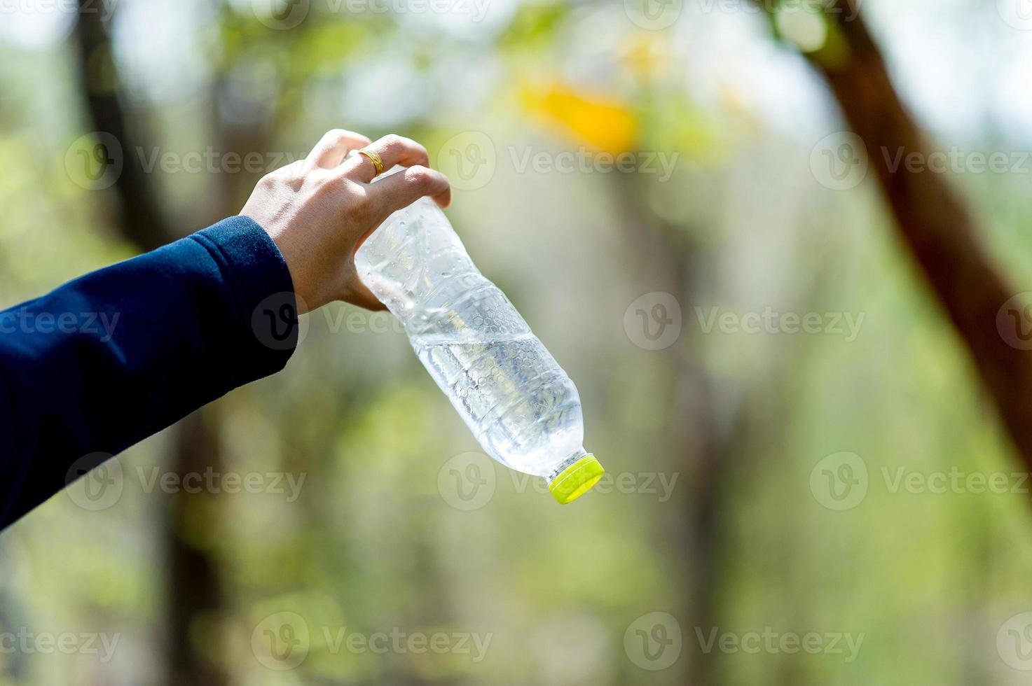 Hand and water bottle Drinking water Creative concept With copy space photo