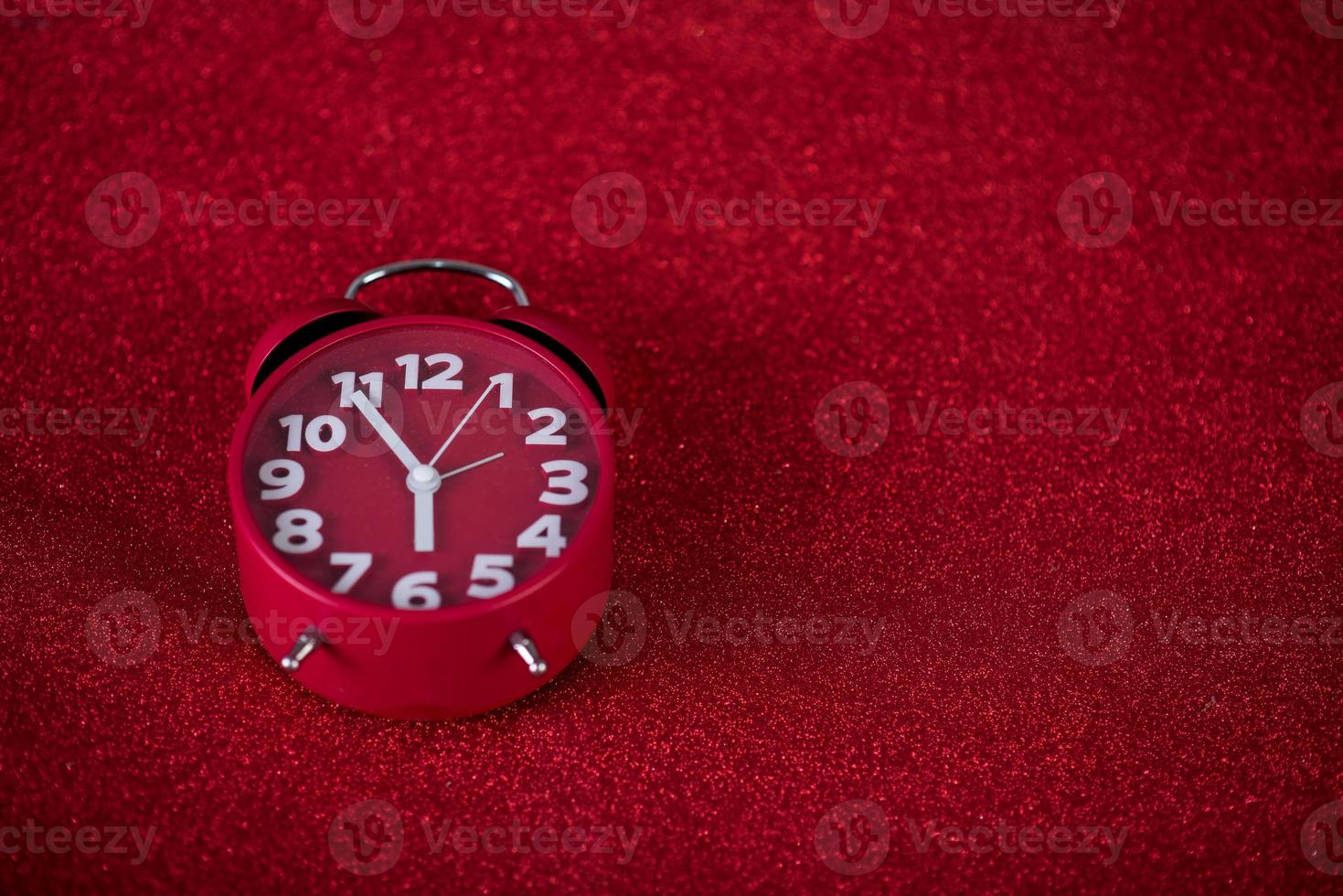 Red background image and beautiful red alarm clock Concept, time, date photo