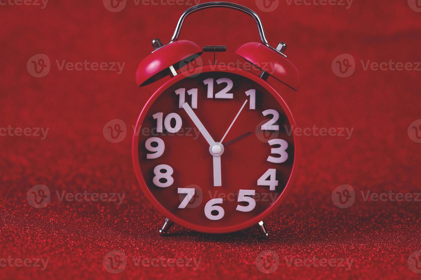 Red background image and beautiful red alarm clock Concept, time, date photo