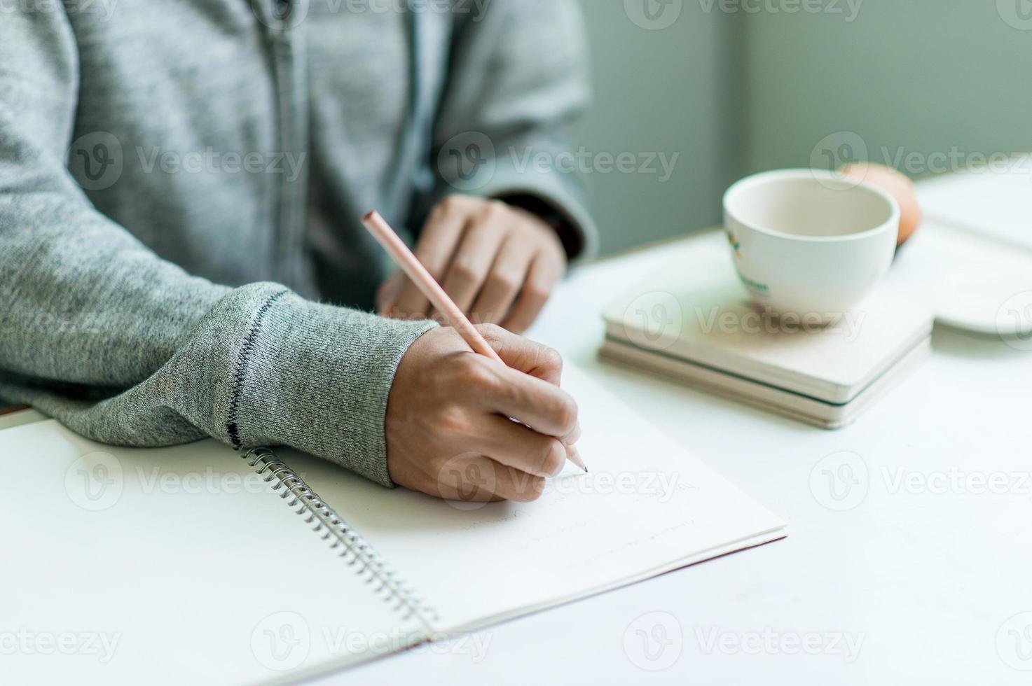 Writing on paper at work on the table in the morning, business ideas. There is space for copying. photo