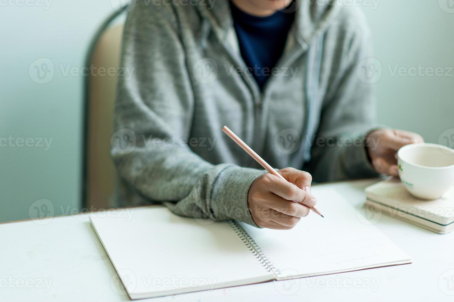 Writing on paper at work on the table in the morning, business ideas. There is space for copying. photo
