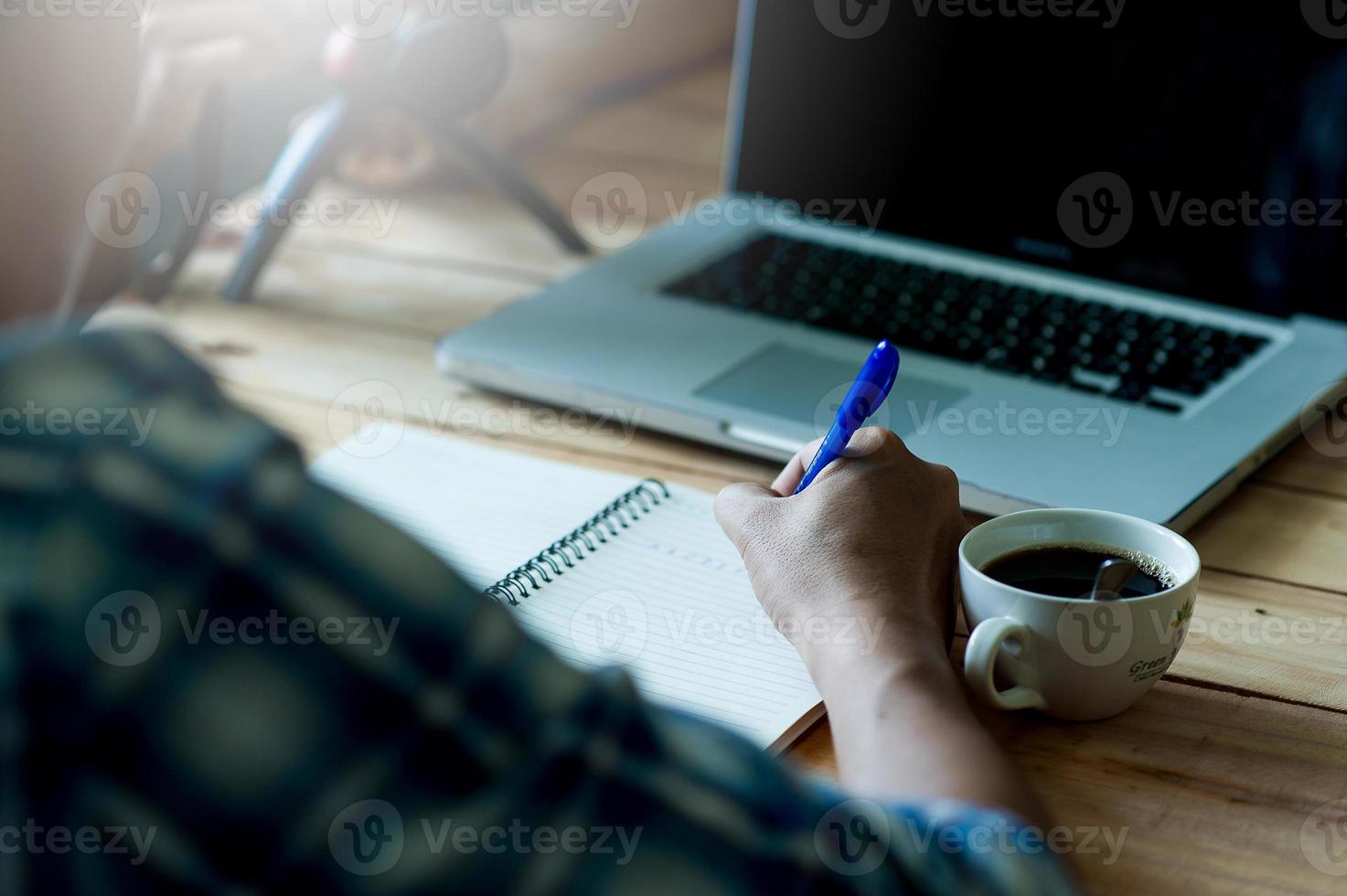 Writing on paper at work on the table in the morning, business ideas. There is space for copying. photo