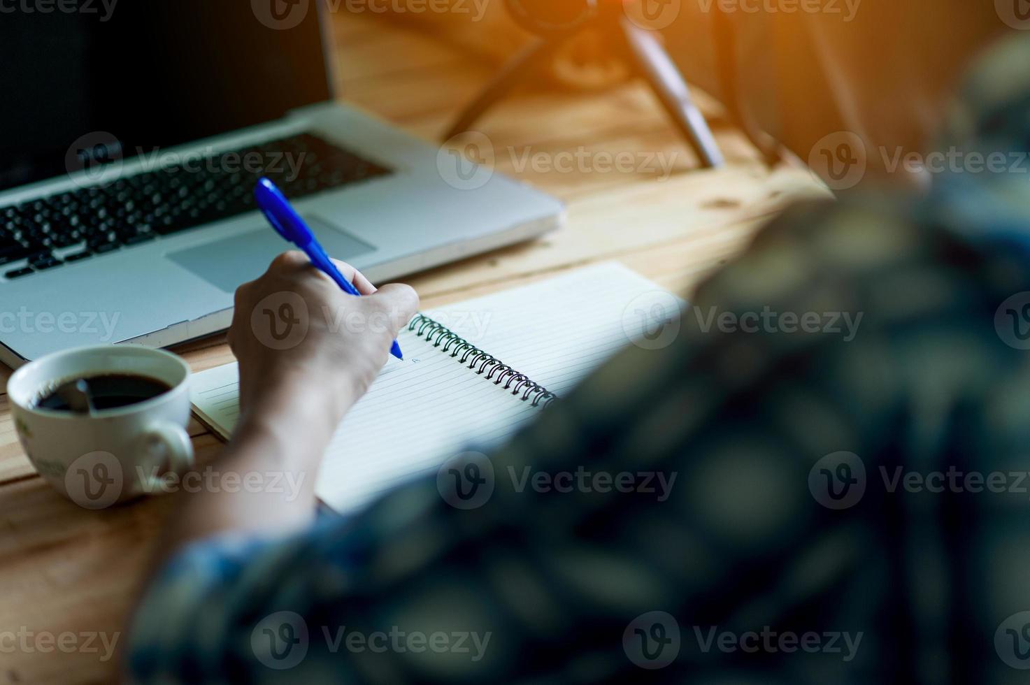 Writing on paper at work on the table in the morning, business ideas. There is space for copying. photo