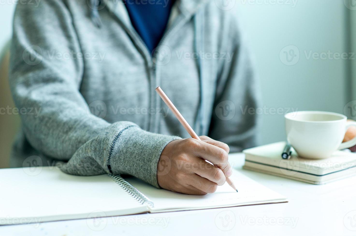 Writing on paper at work on the table in the morning, business ideas. There is space for copying. photo