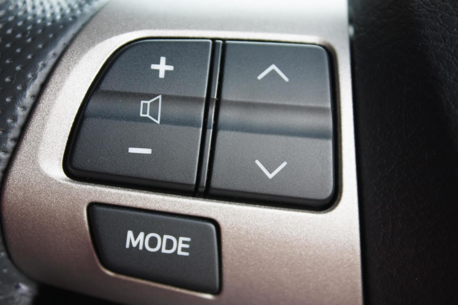 Audio control buttons on the steering wheel of a modern car photo