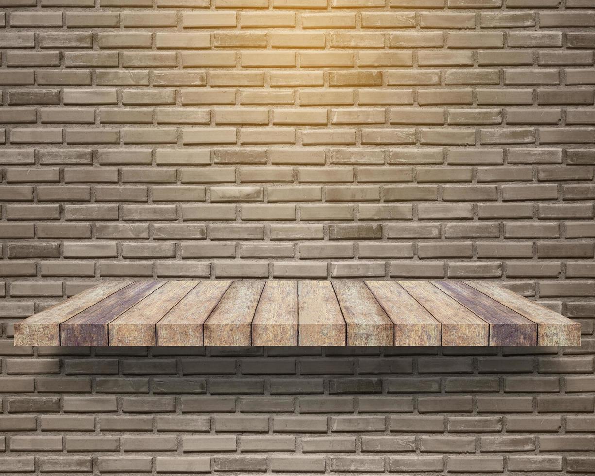 empty wood shelf on brick wall background photo