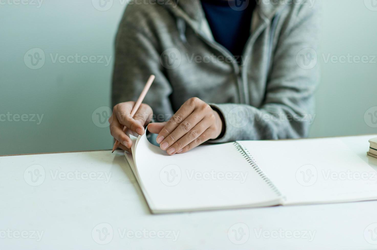 Writing on paper at work on the table in the morning, business ideas. There is space for copying. photo