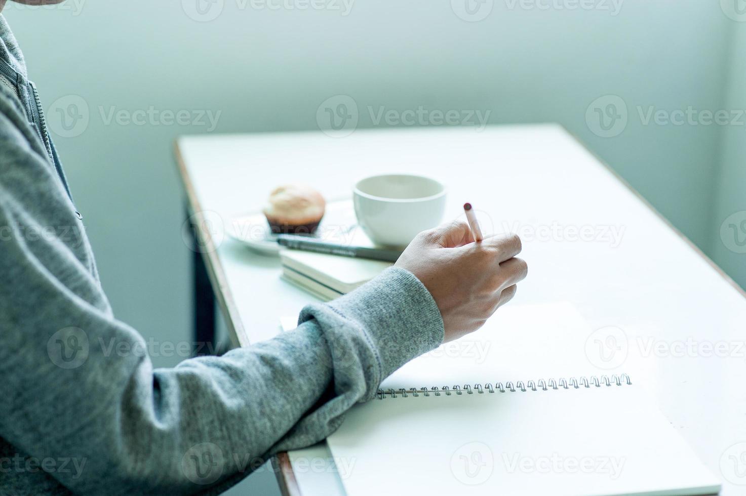 Writing on paper at work on the table in the morning, business ideas. There is space for copying. photo