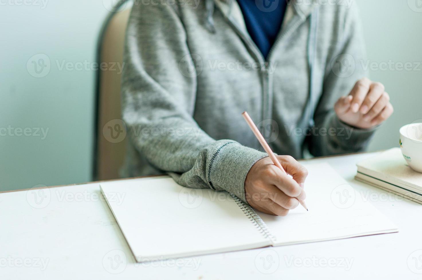 Writing on paper at work on the table in the morning, business ideas. There is space for copying. photo
