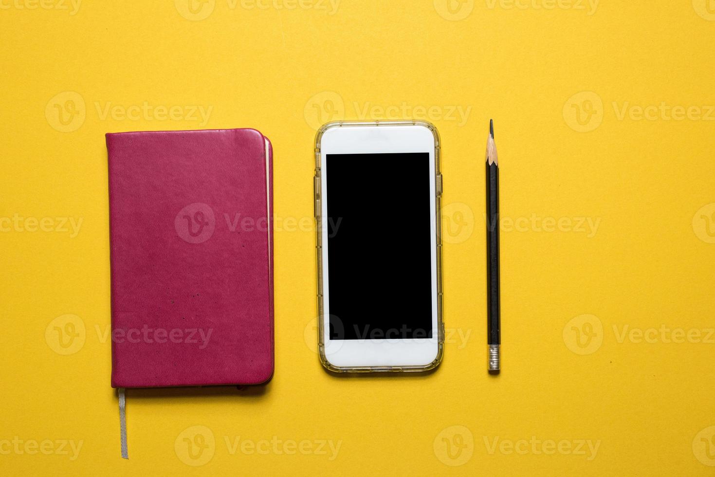 Phones, communication devices placed on a yellow background Technology concept With copy space photo