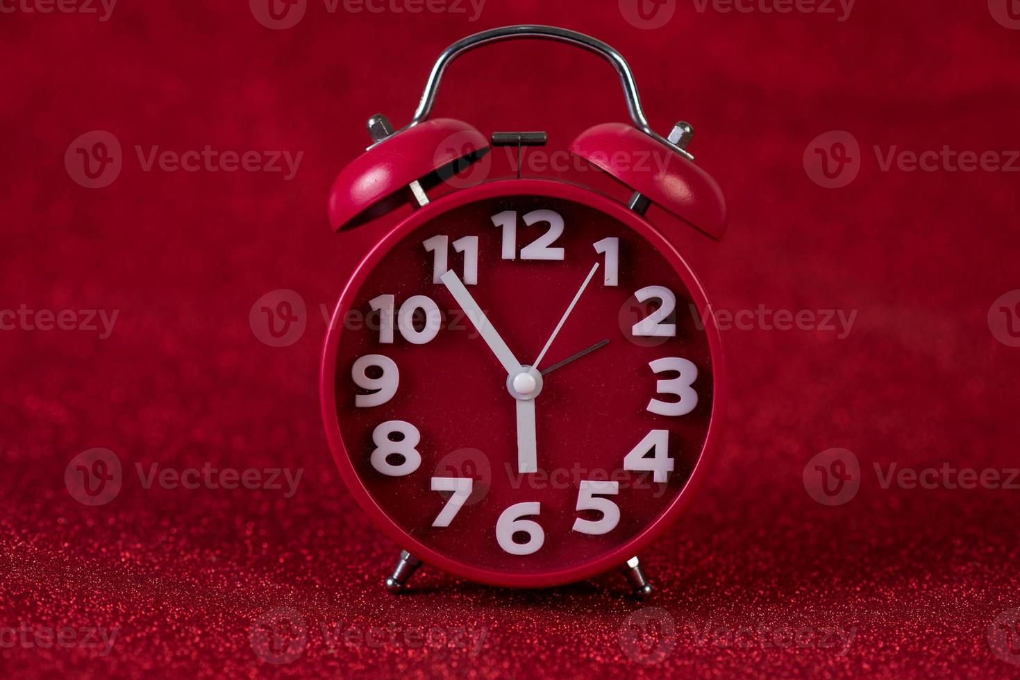 Red background image and beautiful red alarm clock Concept, time, date photo