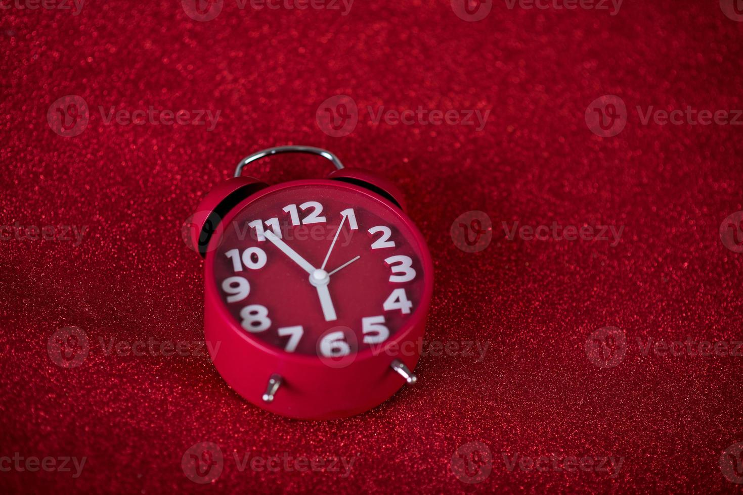 Red background image and beautiful red alarm clock Concept, time, date photo