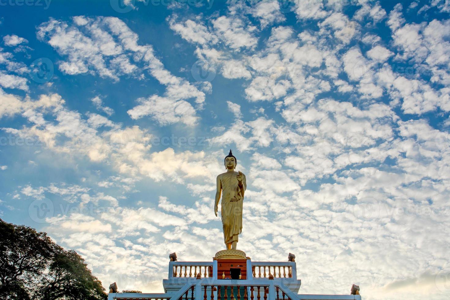 Standing Buddha image And the blue sky, religious concepts photo