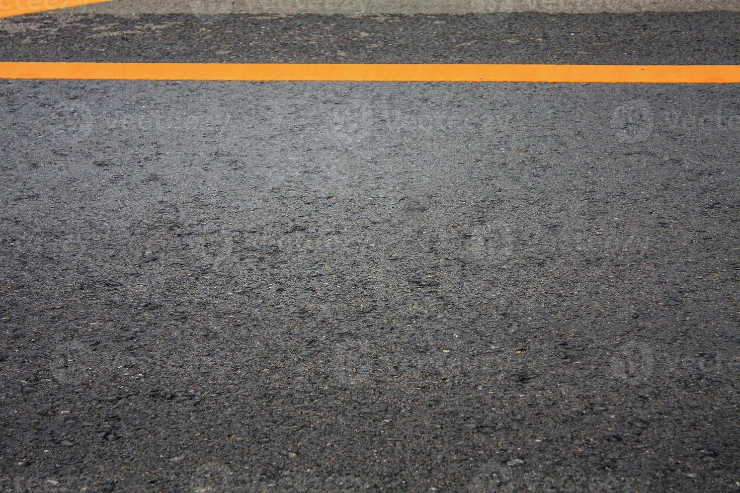 fondo de textura de carretera asfaltada con línea discontinua amarilla foto