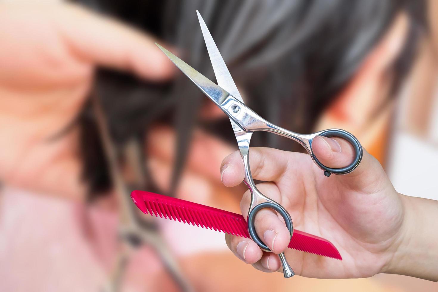 Hairdresser cutting hair in beauty salon photo