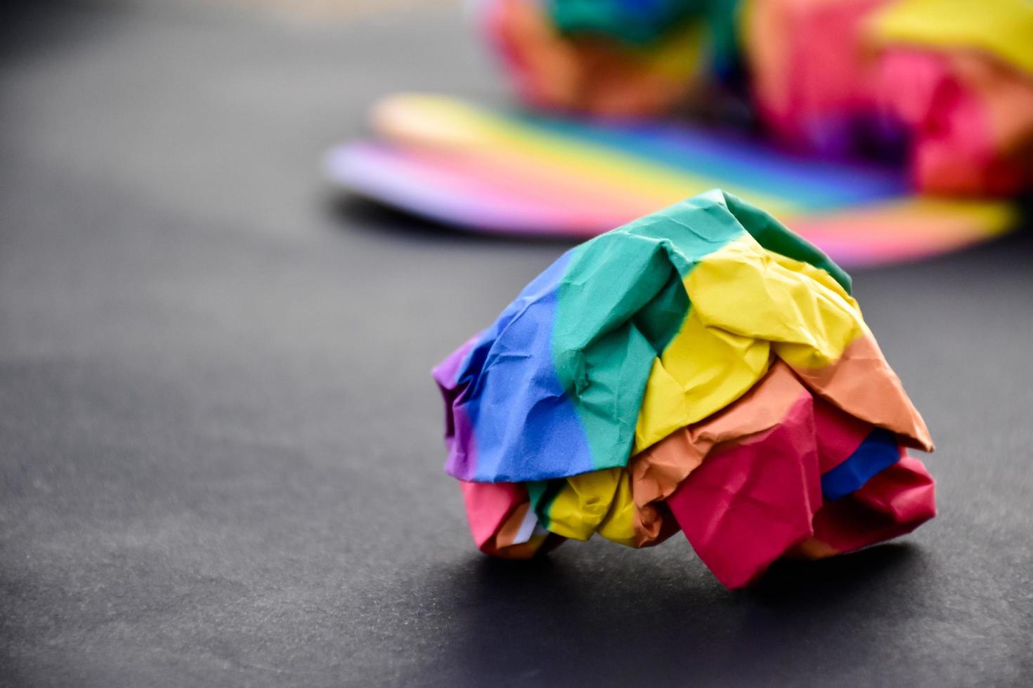 Rainbow colored paper cubes on black and blur background, concept for lgbt celebrations in pride month, June, around the world, soft and selective focus. photo