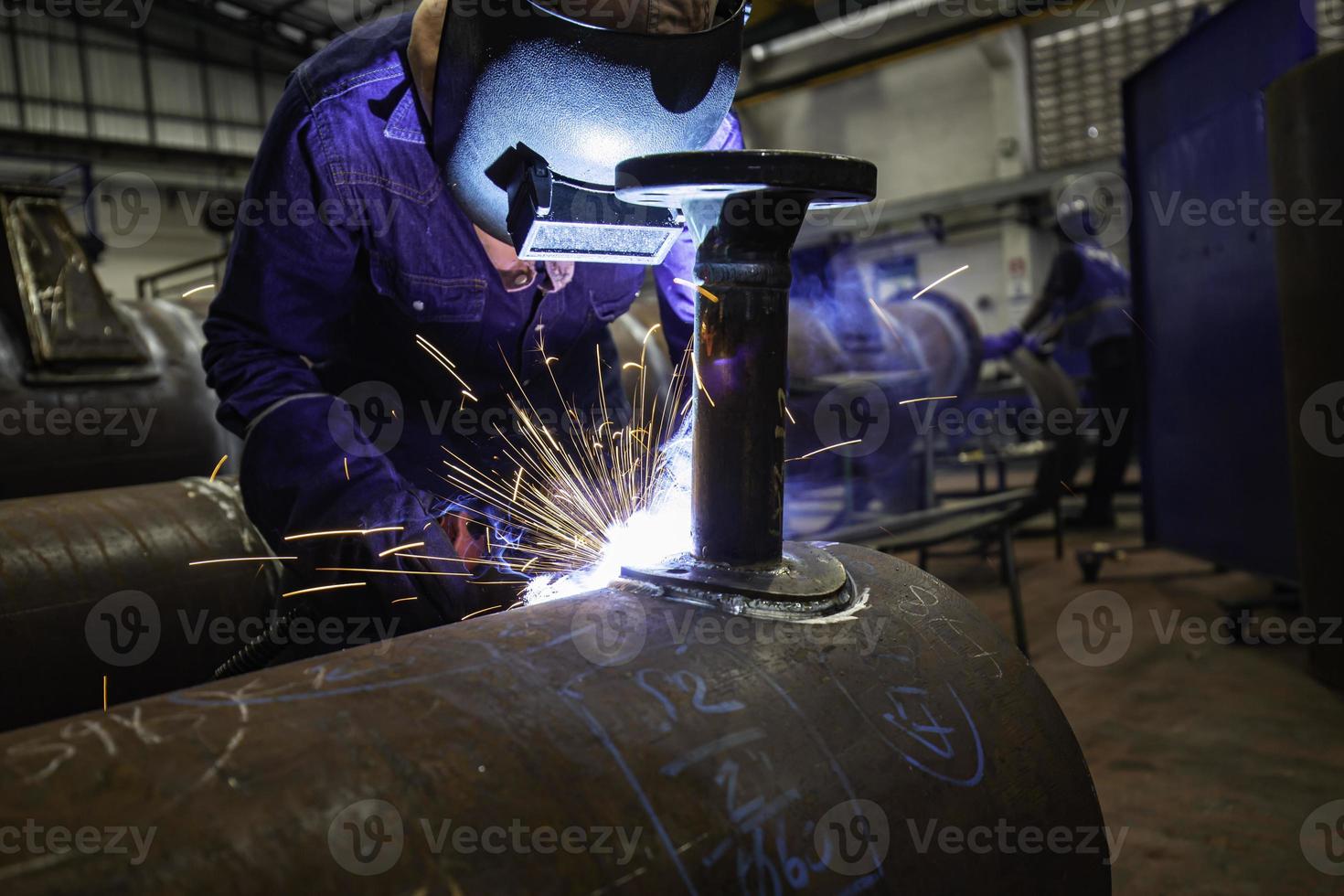 Welding male worker metal is part in machinery nozzle pipeline construction photo