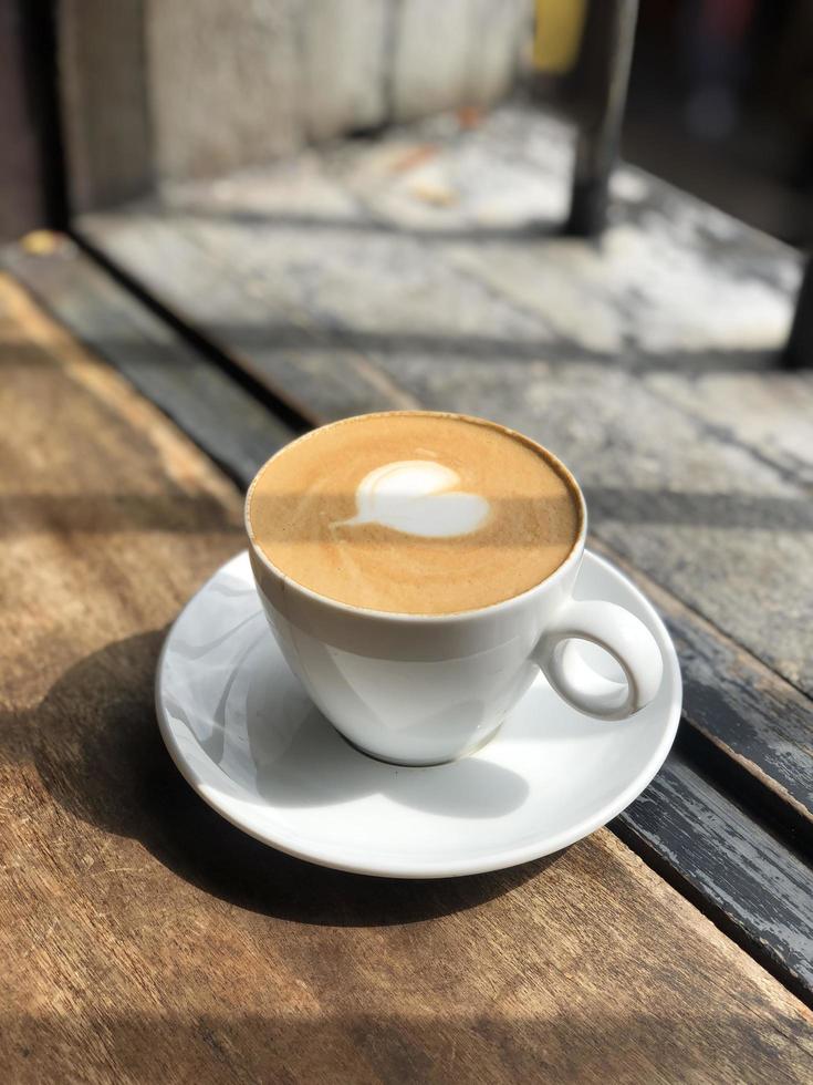 Heart latte art on coffee cup photo