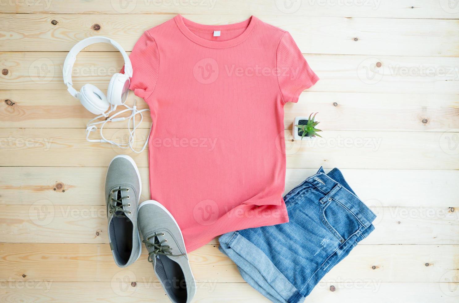 Pink female t shirt mock up flat lay on wooden background. Top front view photo