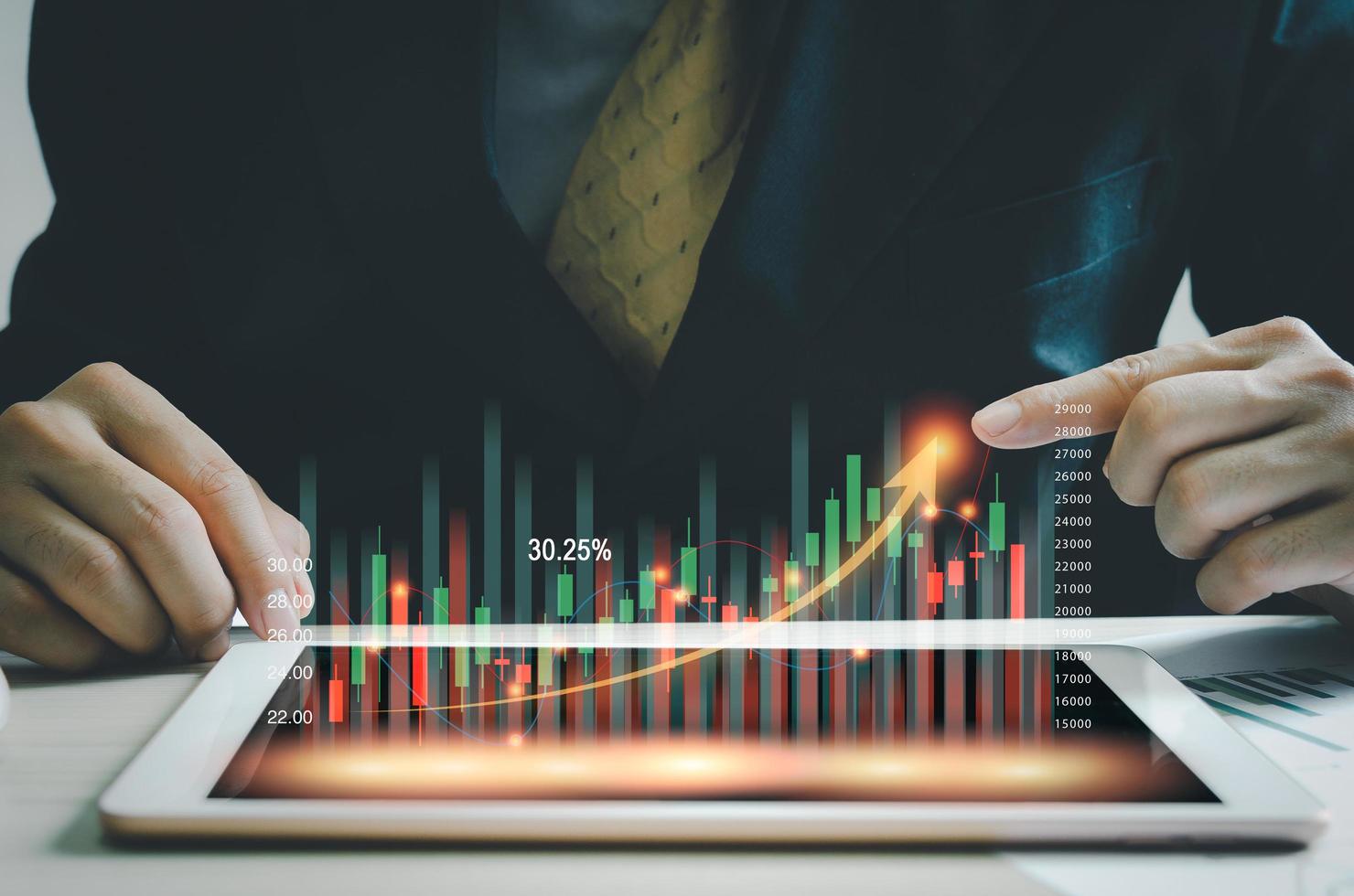 business market finance Index Fun concept.business man holding a graph tablet showing growing virtual hologram stocks. invest in trading photo