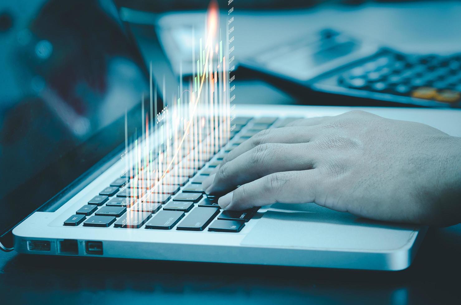 Businessman typing computer laptop and showing graph and char virtual hologram of statistics. Stock market exchange trading graph analysis investment. Business growth, planing and strategy concept. photo