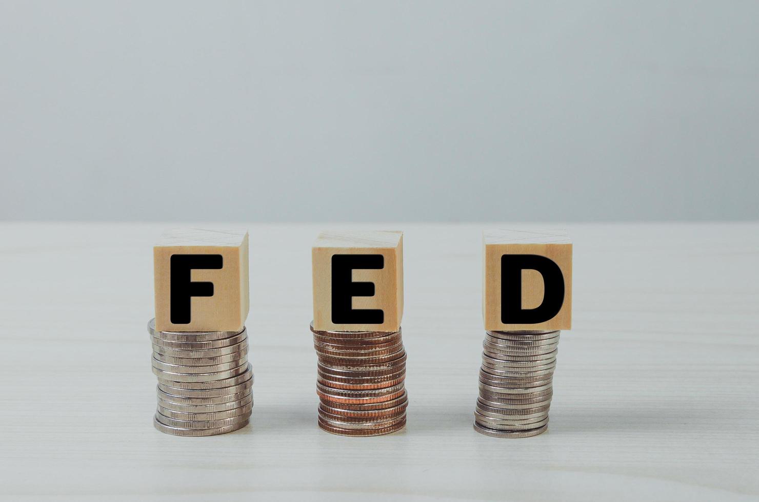 wooden cube block on coins FED text Business Financial Management Economic concepts. photo