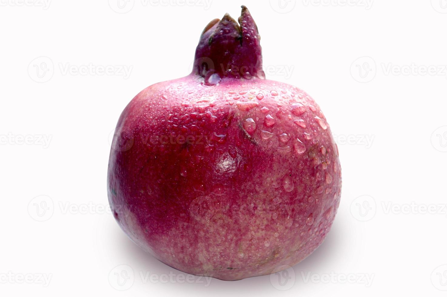 red pomegranate fruit covered with dew drops photo