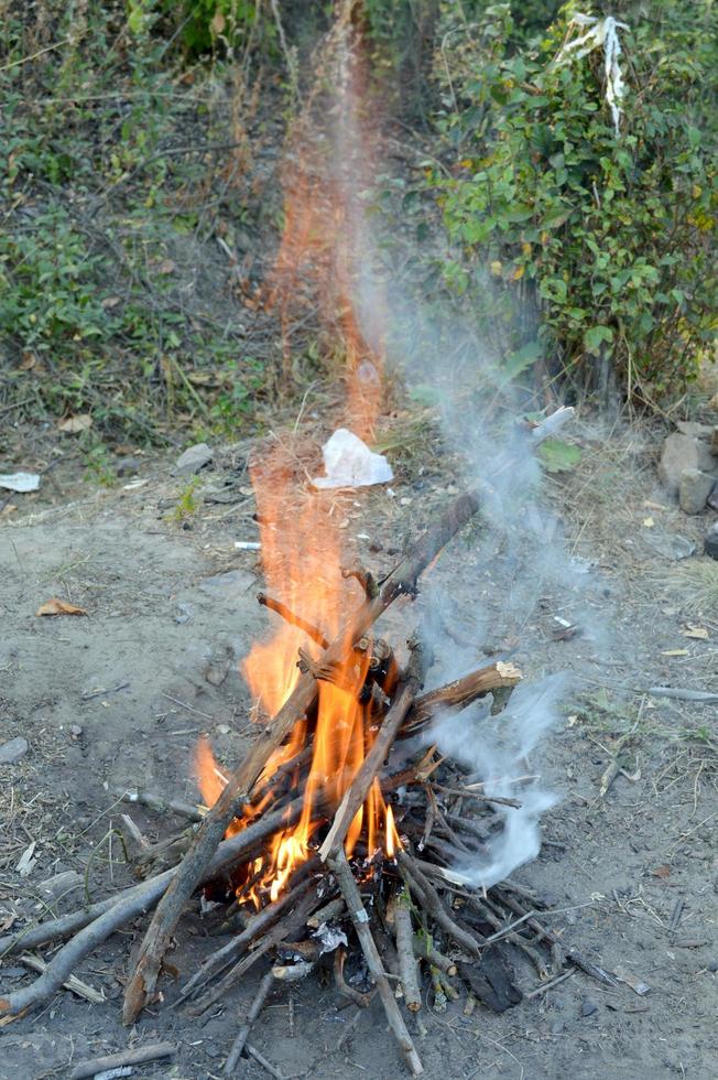 bonfire with burning firewood lined with a pyramid photo