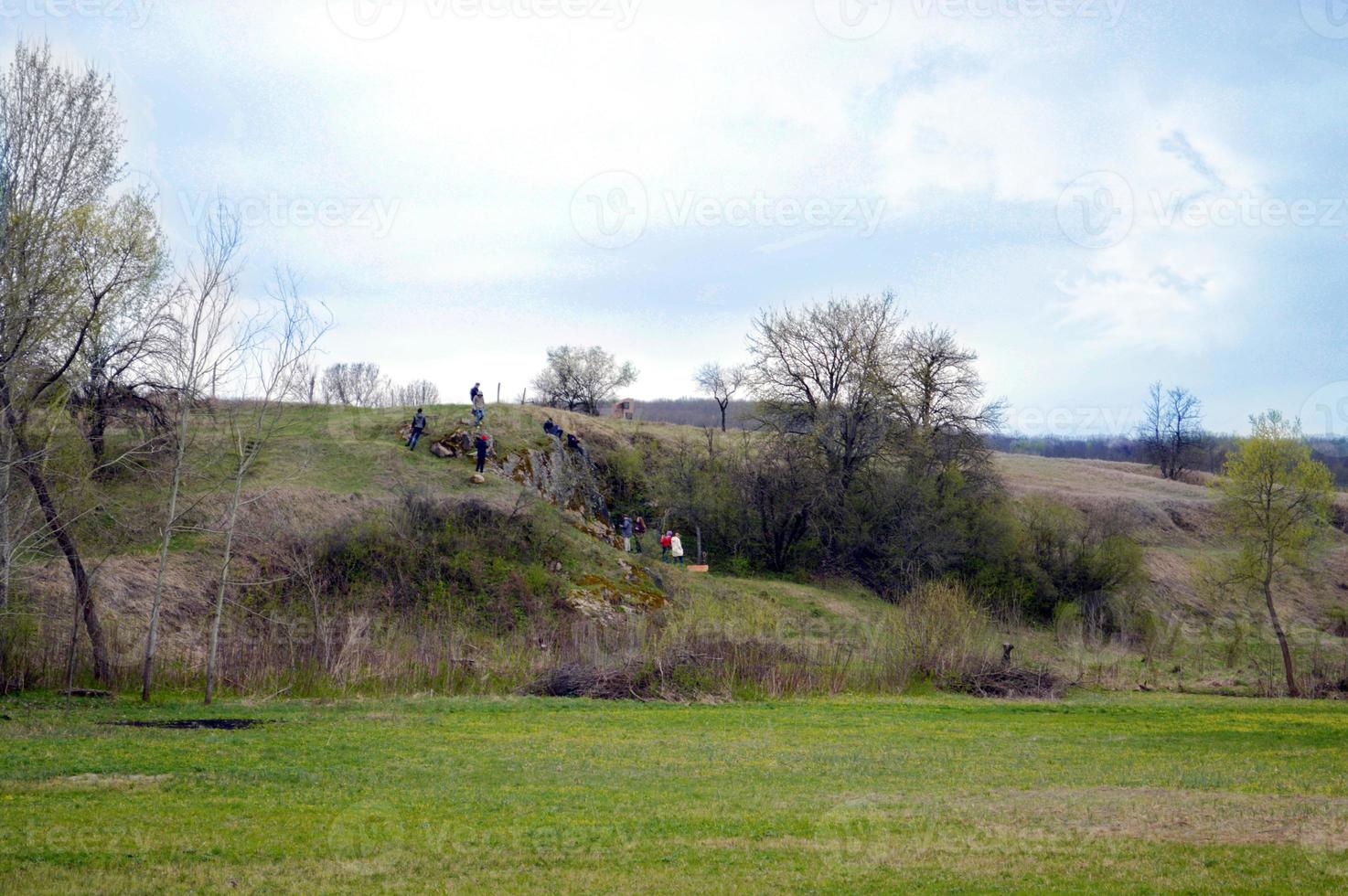 landscape with a plain and a slope with people photo
