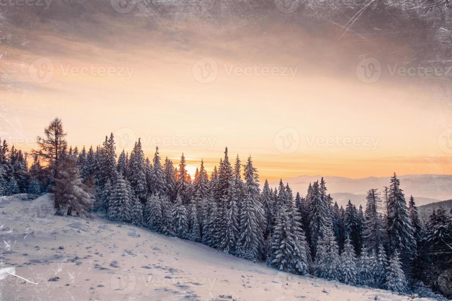 Magic sunset in the snowy mountains. Vintage effect photo