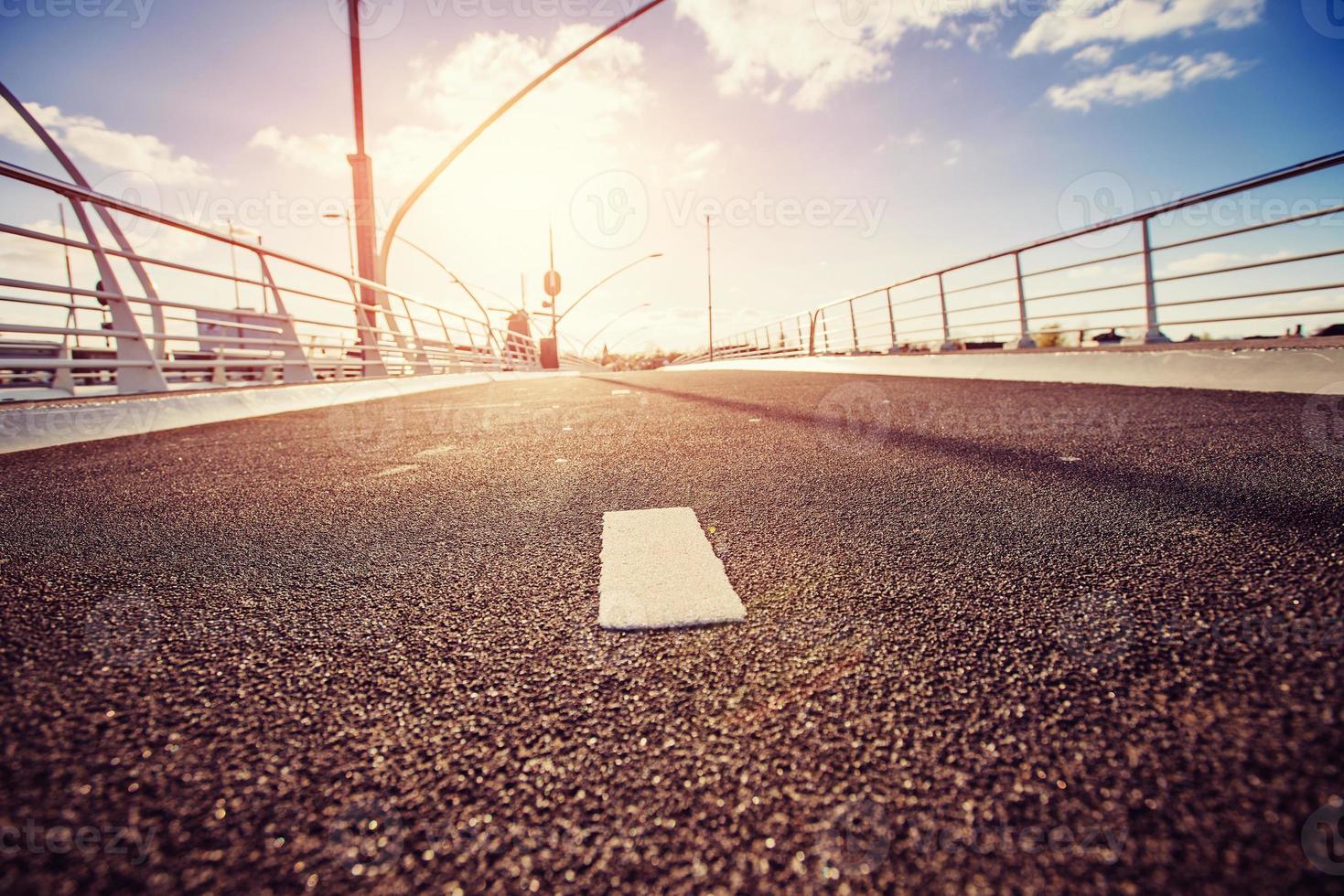 Asphalt road is lit at sunset. photo