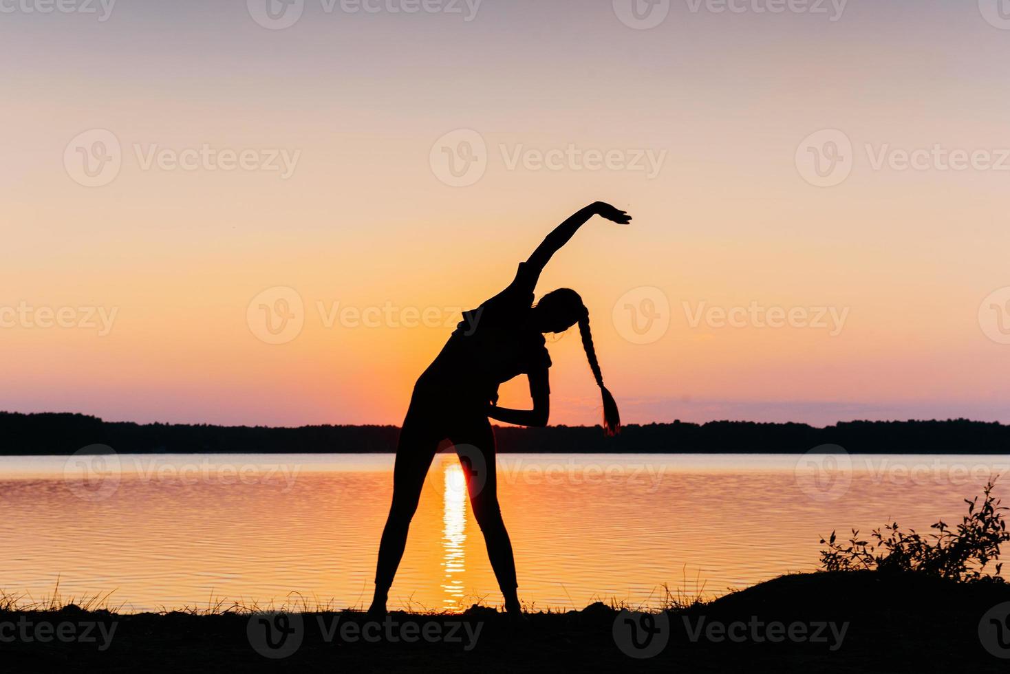 girl at sunset by the lake photo