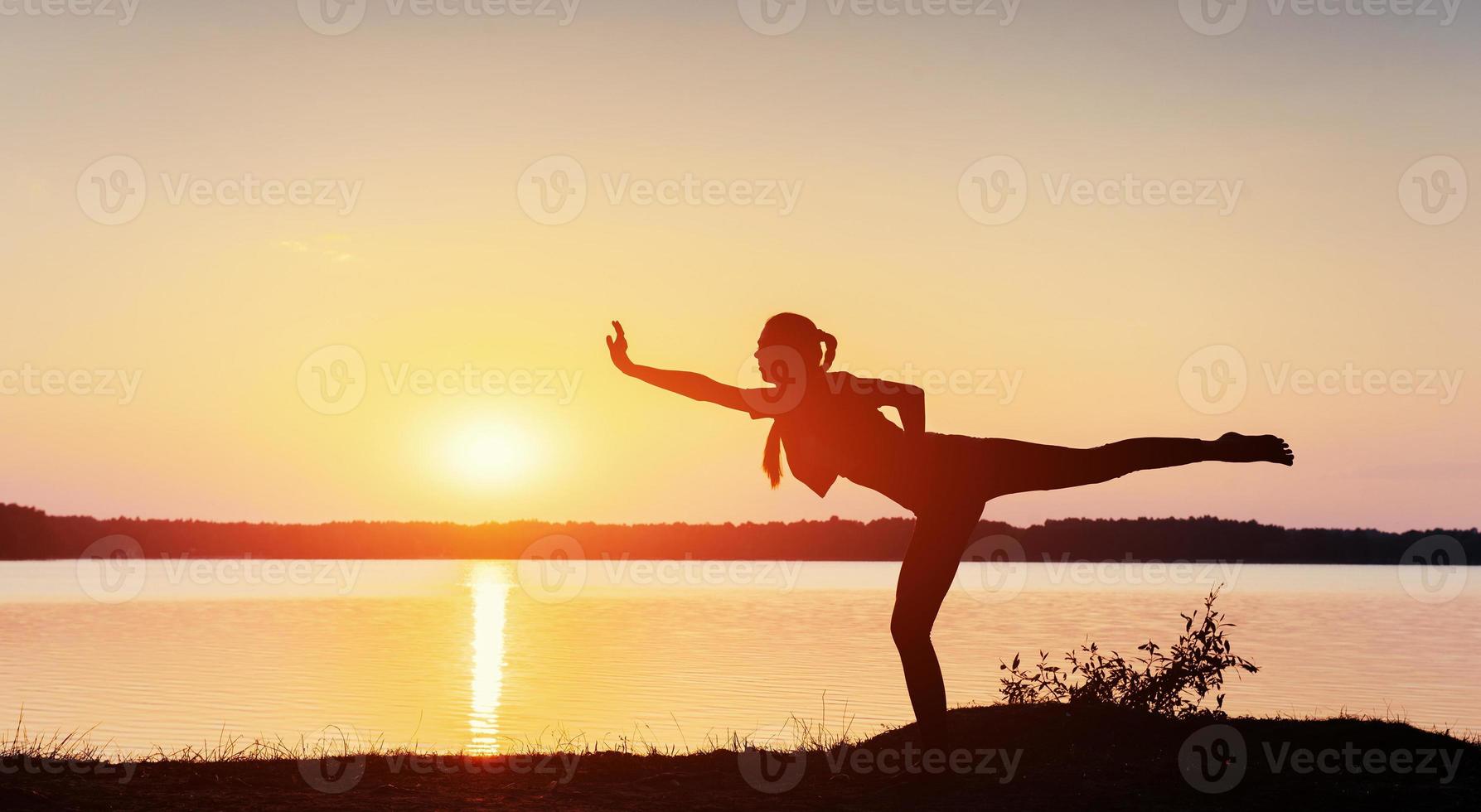 girl at sunset by the lake. photo
