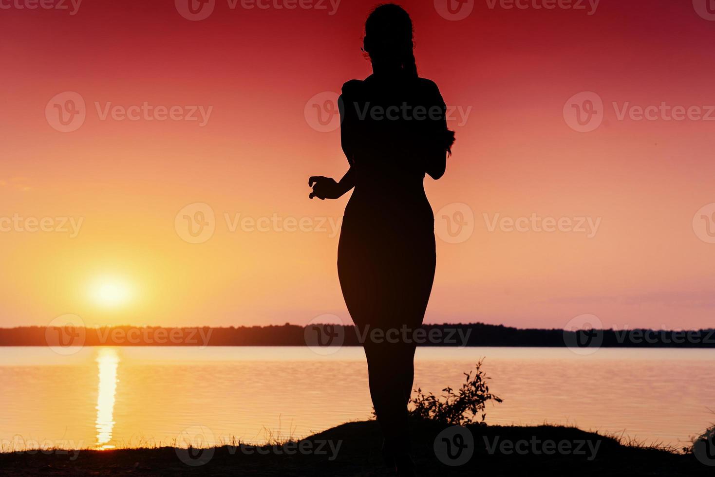 girl at sunset by the lake photo