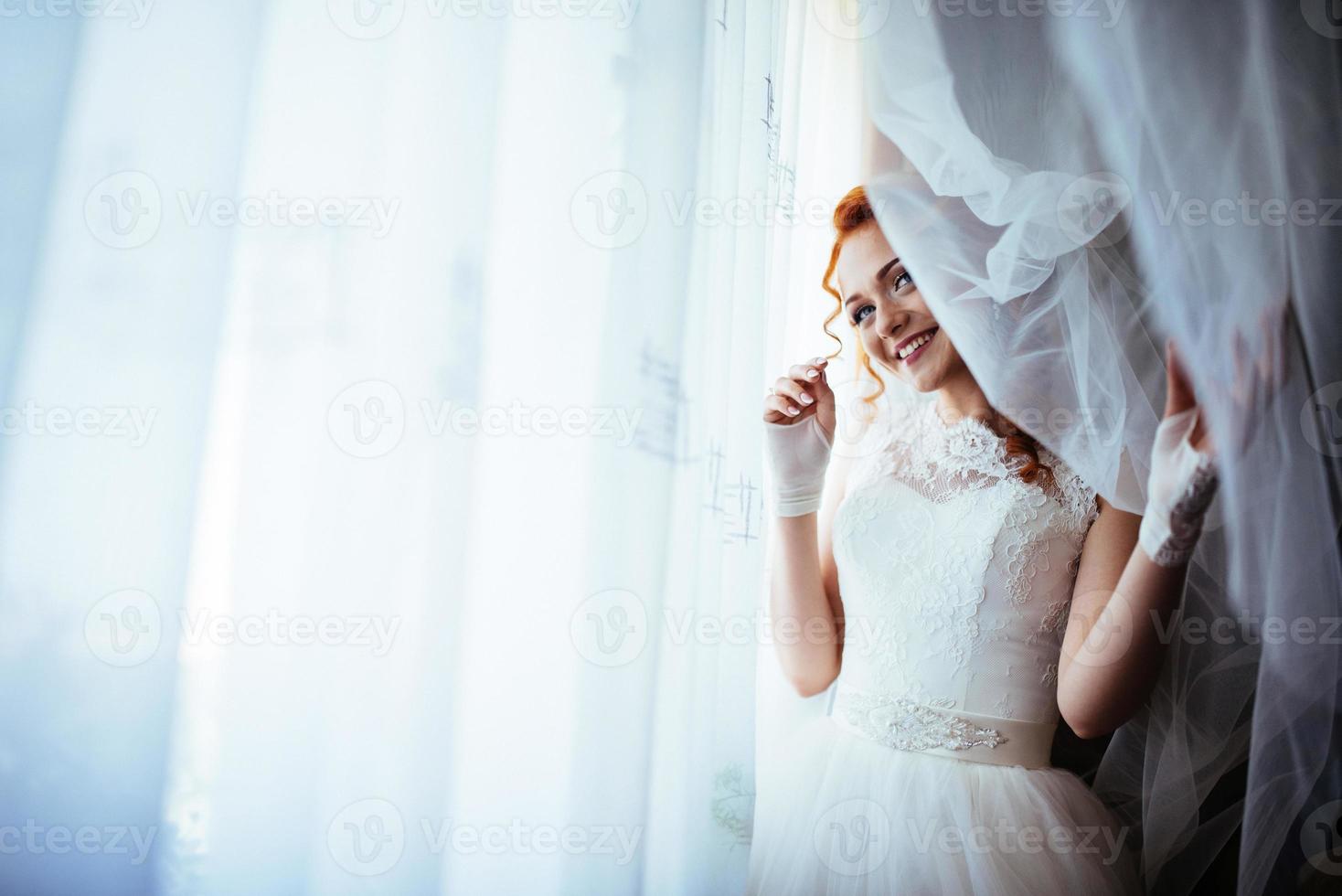 Bride near curtains photo