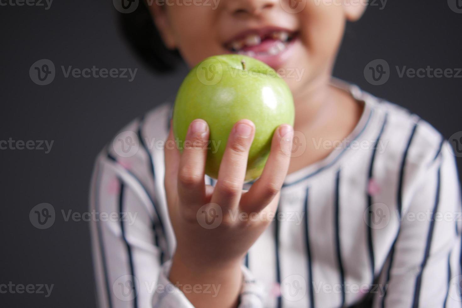 child girl hand hold a apple selective focus photo