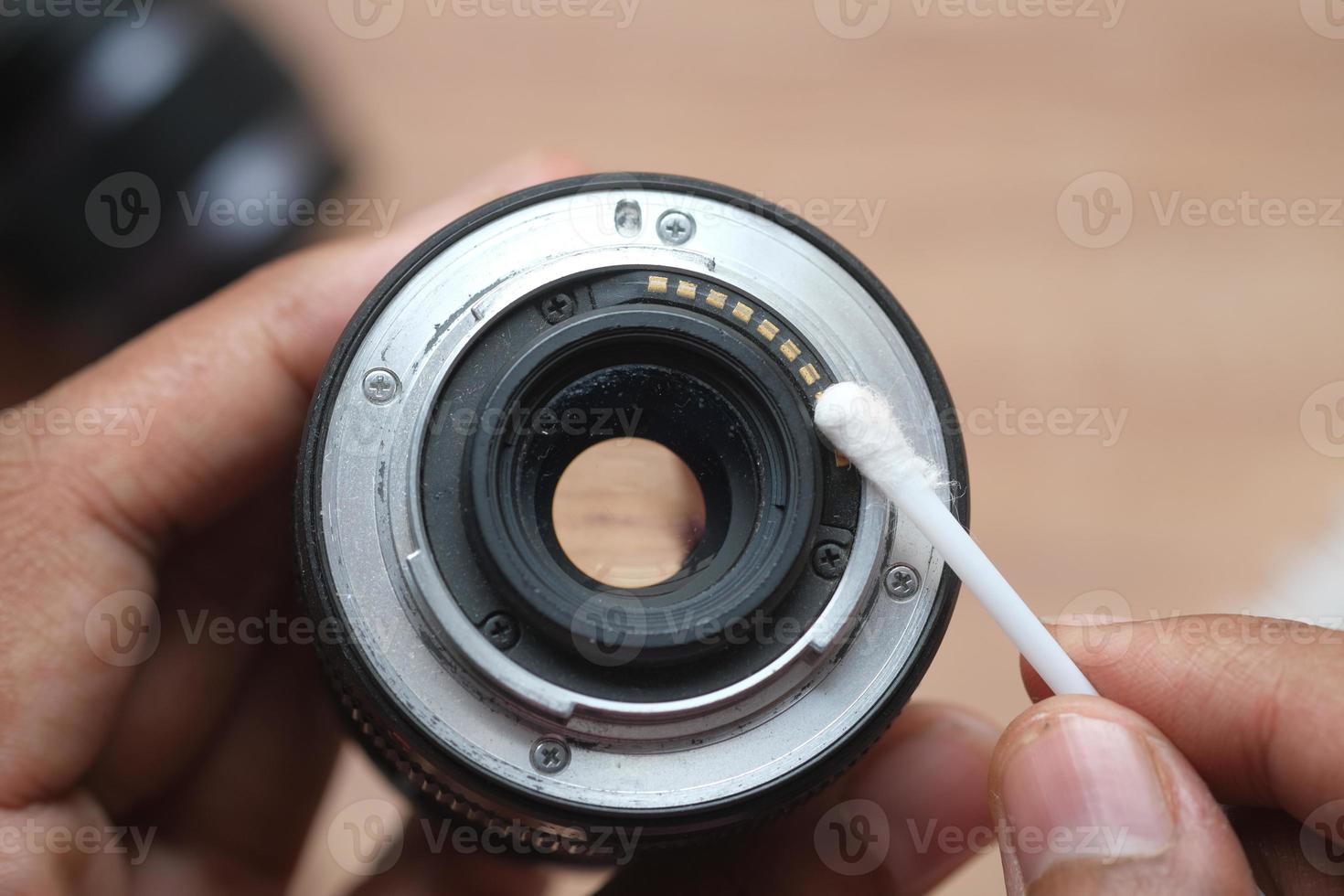 close up of cleaning camera lens photo