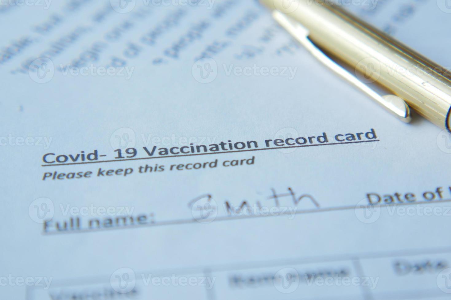 vaccination record card , hand sanitizer and mask on color background photo