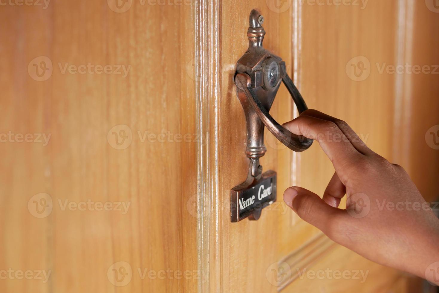 young man hand knocking door, photo