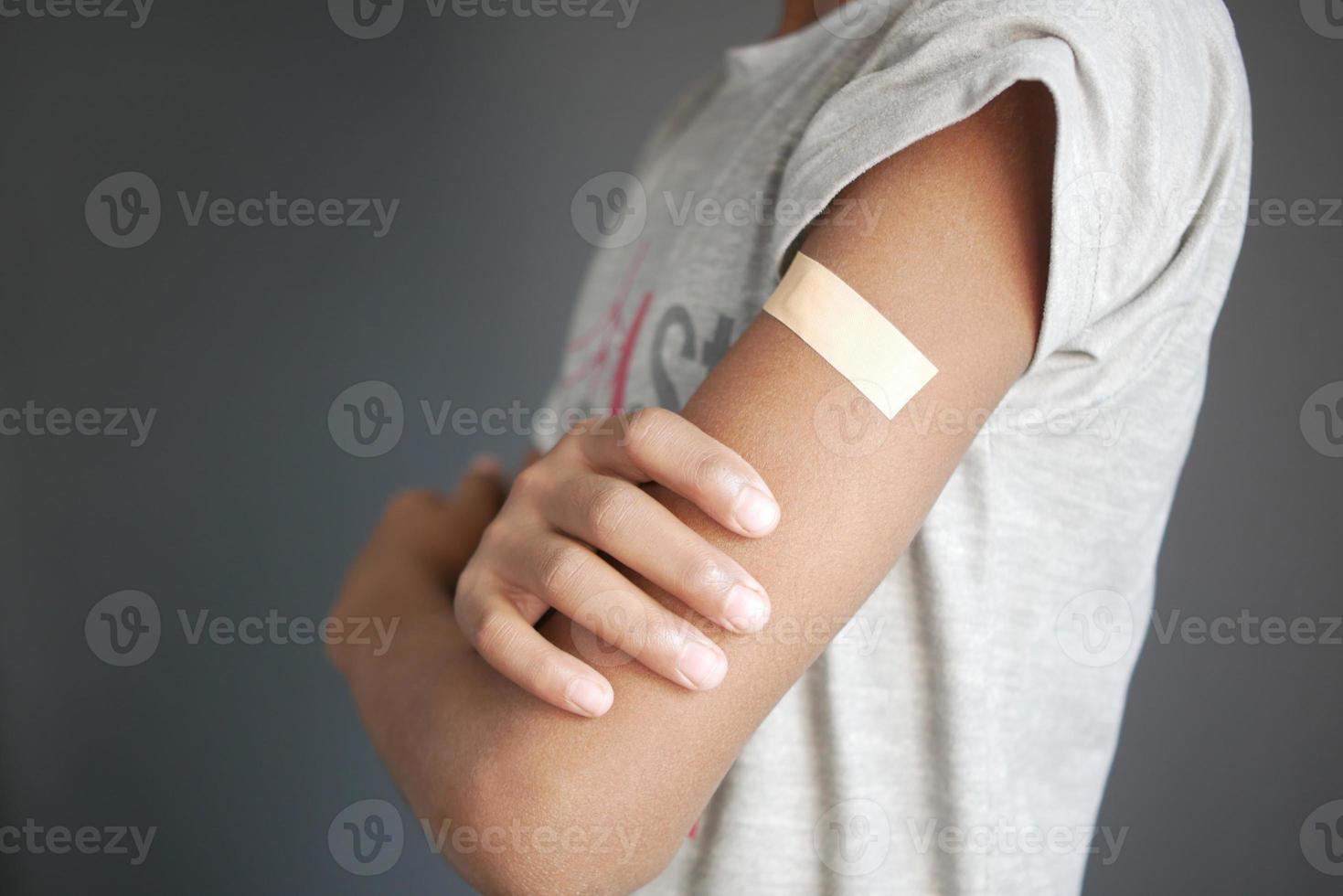 adhesive bandage on young man's arm photo