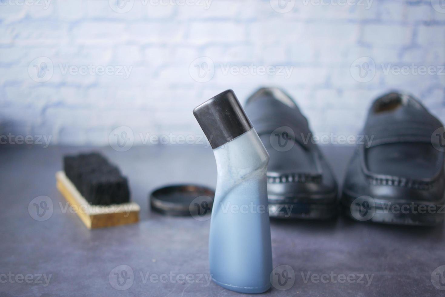 cleaning Shoe with a brush on floor photo