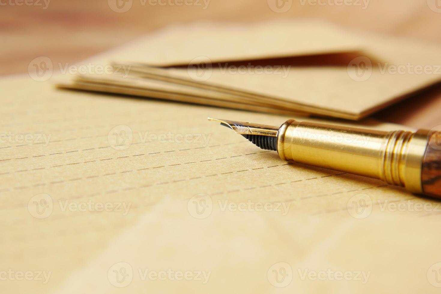 envelope , empty paper and fountain pen on table photo