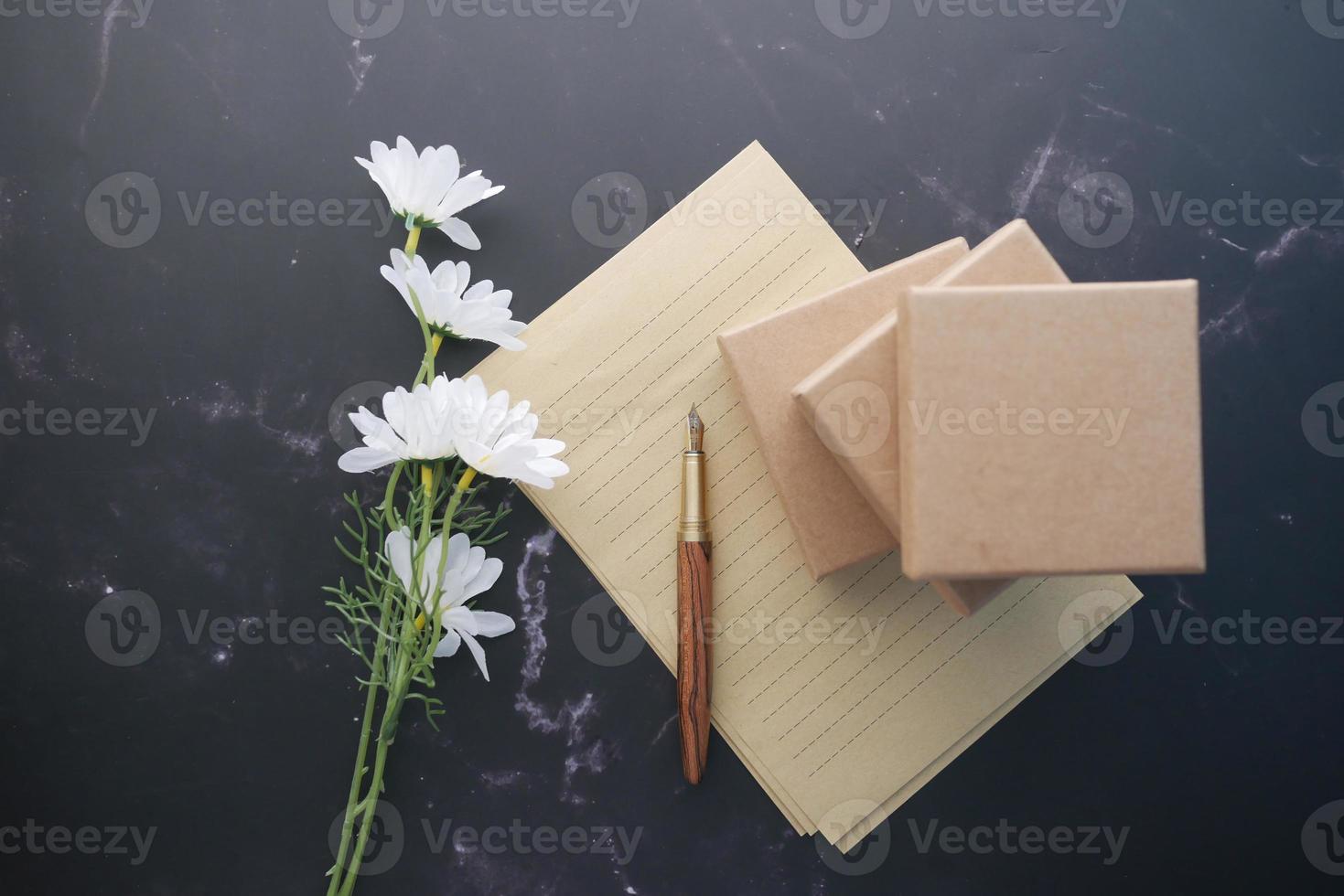 envelope , empty paper and fountain pen on table photo