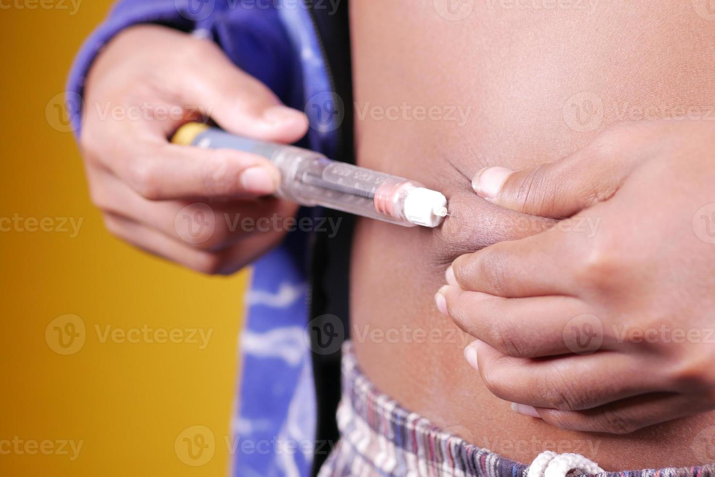 young man hand using insulin pen close up photo