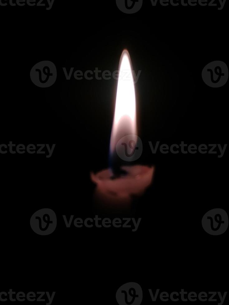 Close up of lighting candles in darkness photo